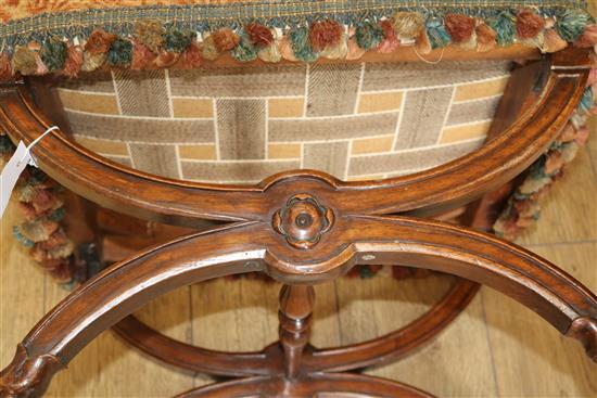 A Victorian rosewood X shaped stool, with old tapestry upholstered top, W.52cm